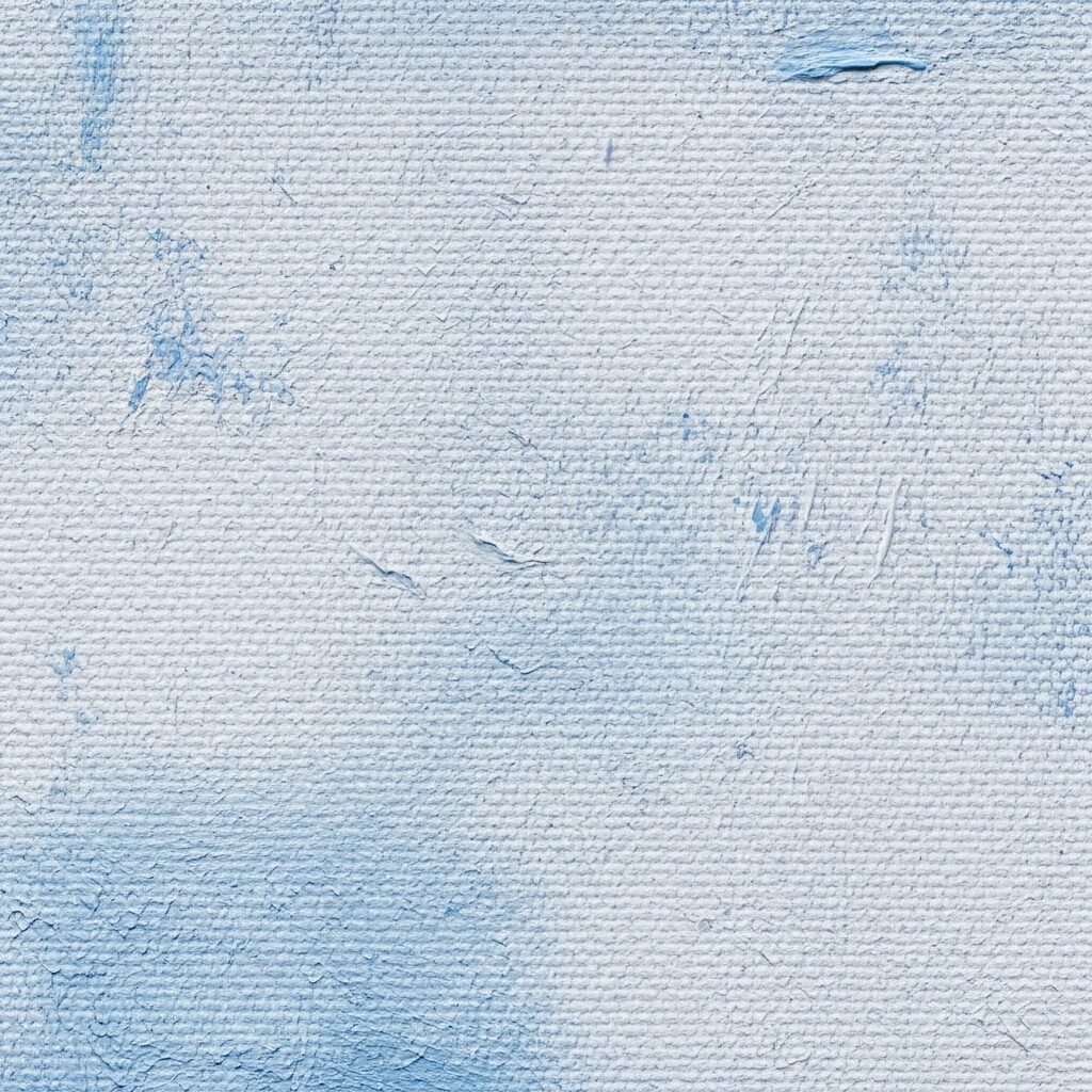 An extreme close-up photograph showcasing the intricate texture of a stretched canvas with dried acrylic paint. 