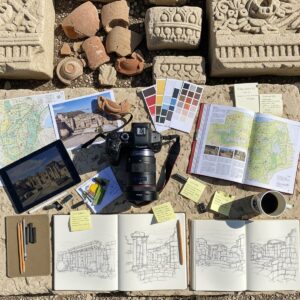 Photography equipment and sketchbook setup at archaeological sites for gathering landscape painting references
