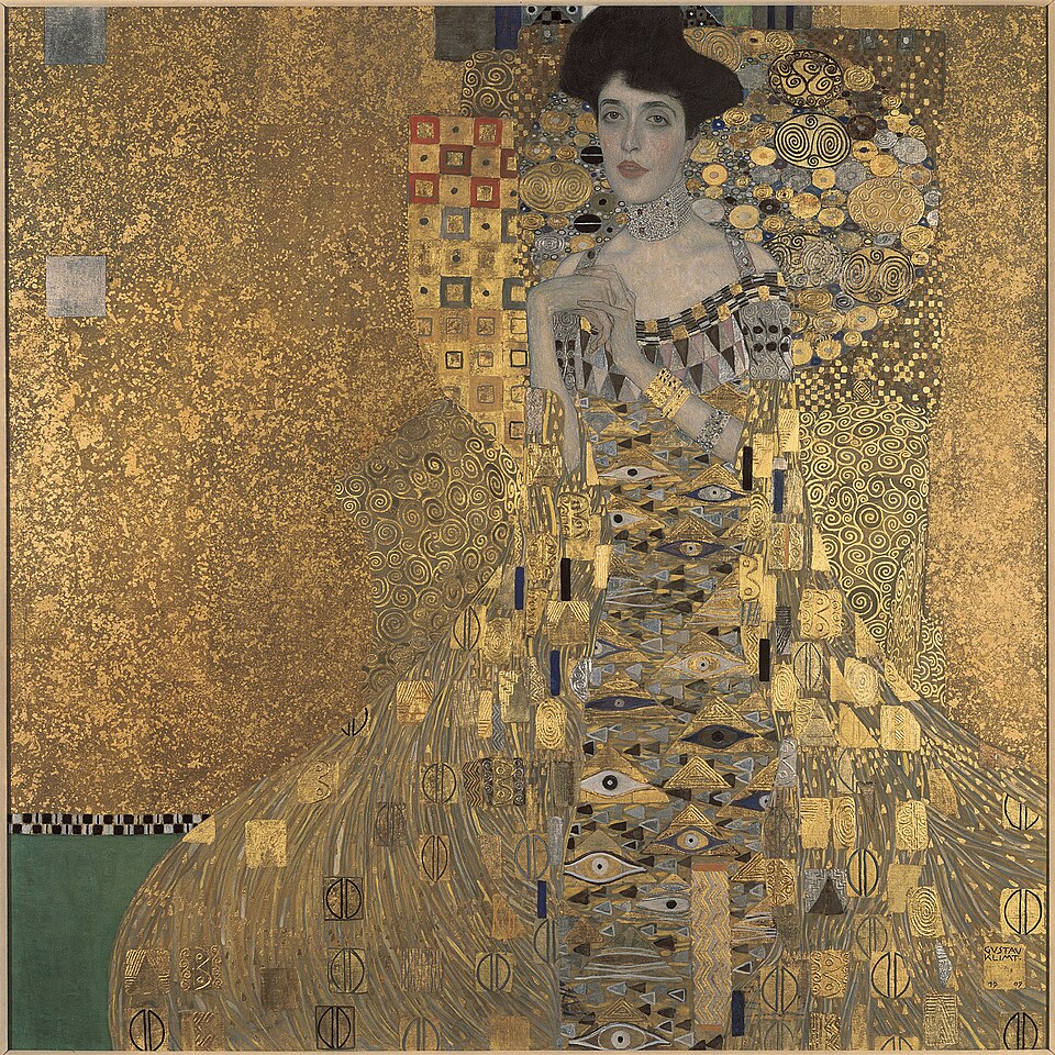 Golden Masterpieces: Discover the Top 10 Gustav Klimt Paintings 5 "Portrait of Adele Bloch-Bauer I (The Woman in Gold)" by Gustav Klimt, painted in 1907. Description: Famously known as 'The Woman in Gold,' this portrait is a breathtaking example of Klimt's ability to merge a person with pure decoration. Adele Bloch-Bauer, a wealthy Viennese socialite, seems to float in a sea of gold, her gown and the background swirling together with eyes, triangles, and spirals. Only her face and hands emerge realistically from the shimmering mosaic. The painting was famously looted by the Nazis during WWII and was only returned to Adele's niece after a long legal battle.. Interesting fact: It took Gustav Klimt three years to complete this complex and lavish portrait.