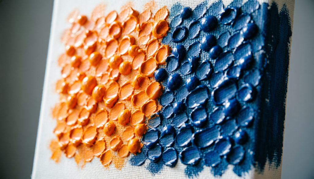 Impressionist Color Palette for Beginners: Close up of small dabs of orange and blue paint side-by-side demonstrating optical color mixing.